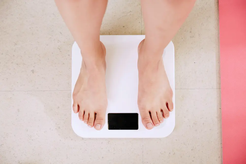 Woman reading weight on scale